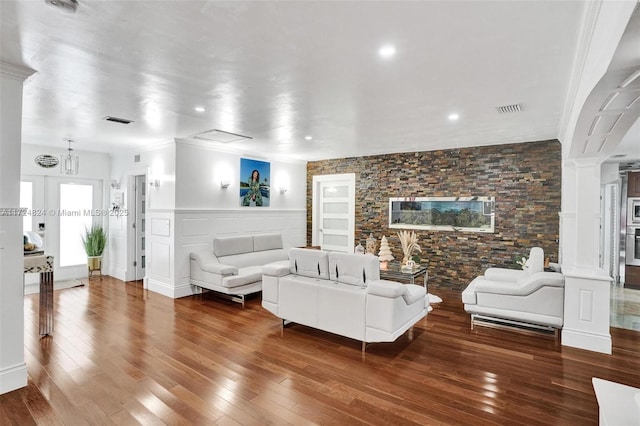 living room with hardwood / wood-style flooring and ornate columns