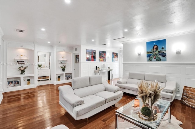 living room with crown molding, built in features, and dark hardwood / wood-style floors