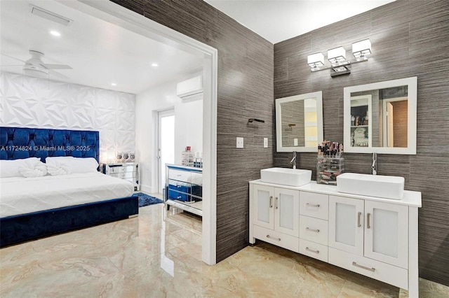 bedroom featuring sink, ceiling fan, and tile walls