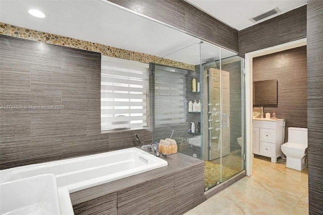 full bathroom with separate shower and tub, toilet, tile walls, and vanity