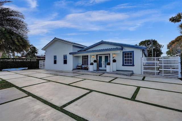 view of front of house featuring french doors and a patio