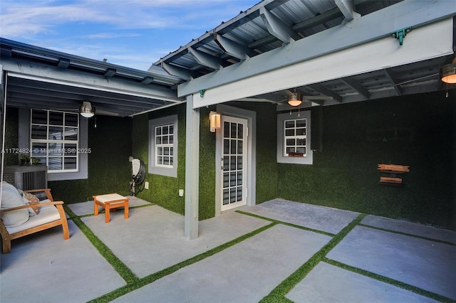 view of patio with ceiling fan and central AC unit