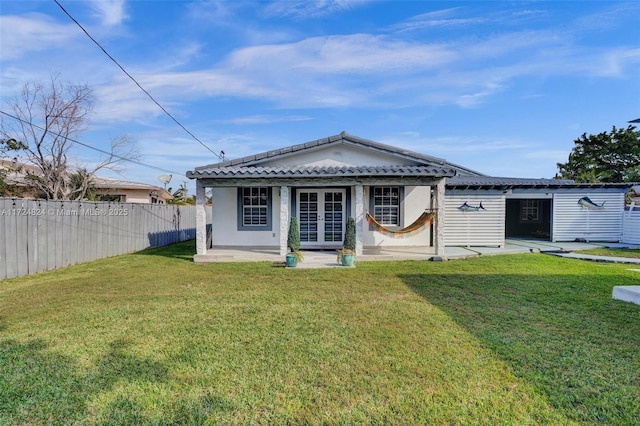 back of property featuring a yard and a patio