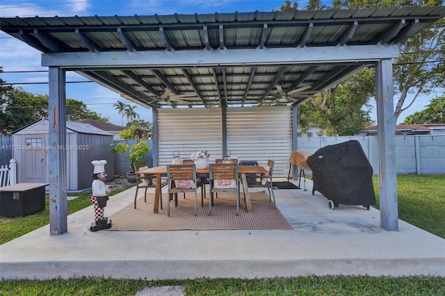 view of patio with a shed and grilling area