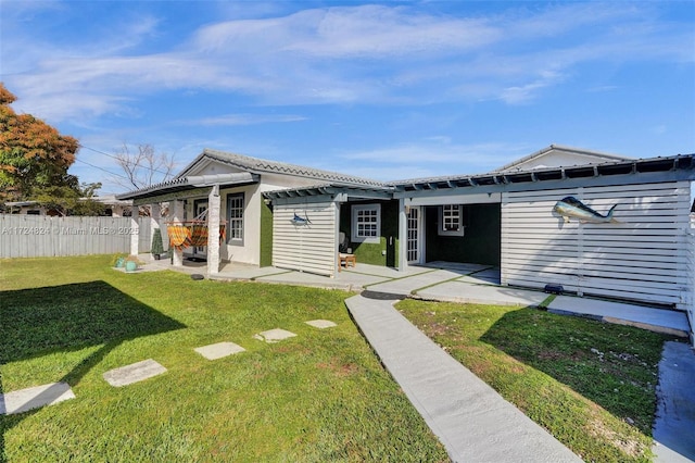 view of front facade with a patio area, a front yard, and a pergola