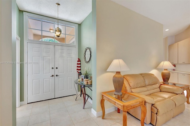 tiled entrance foyer featuring a textured ceiling