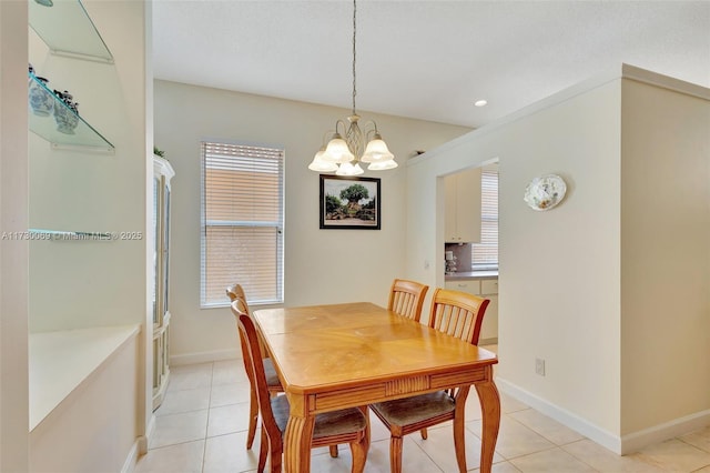 dining space featuring a notable chandelier, light tile patterned floors, and plenty of natural light