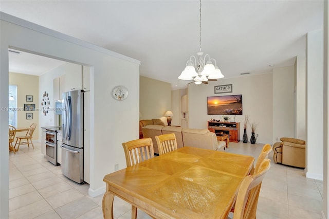 tiled dining area with a notable chandelier