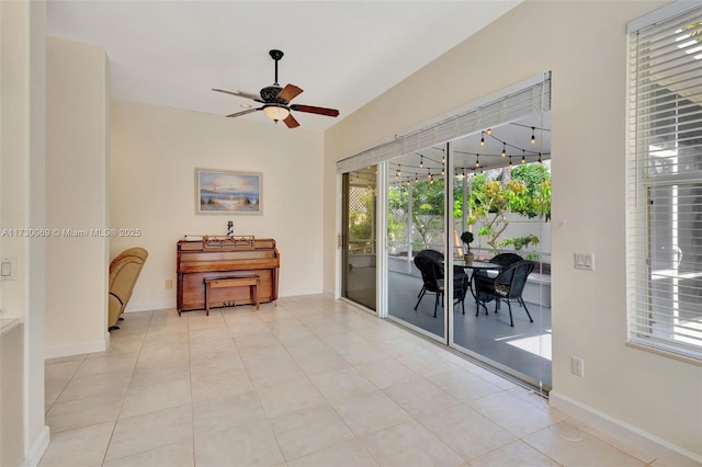 interior space with ceiling fan and light tile patterned floors