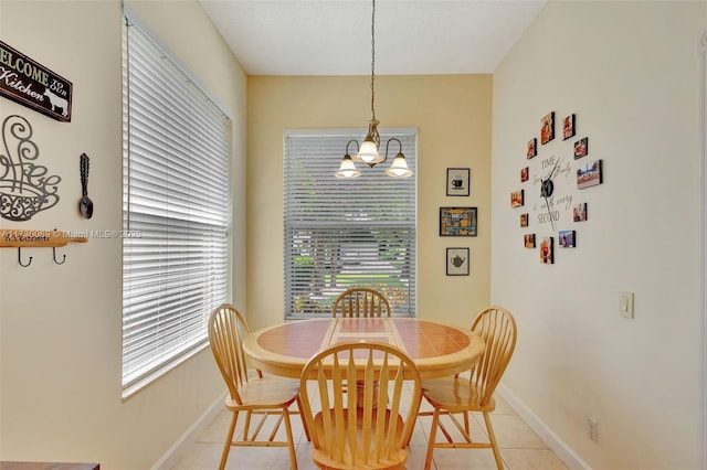 tiled dining area with an inviting chandelier