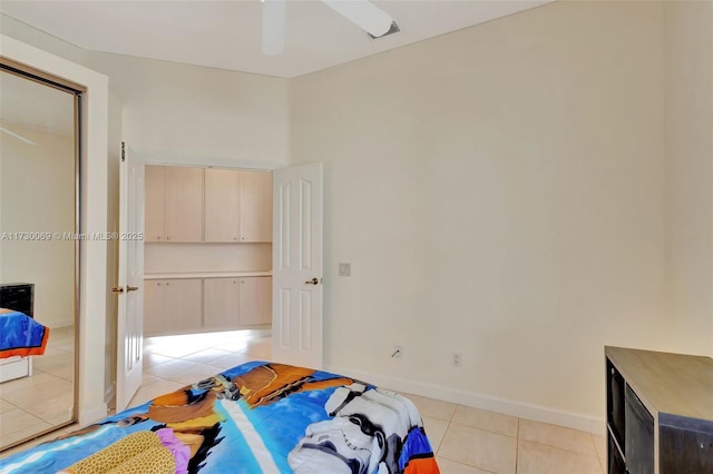 bedroom with light tile patterned flooring, a closet, and ceiling fan