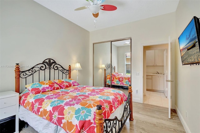 bedroom featuring light hardwood / wood-style flooring, a closet, and ceiling fan