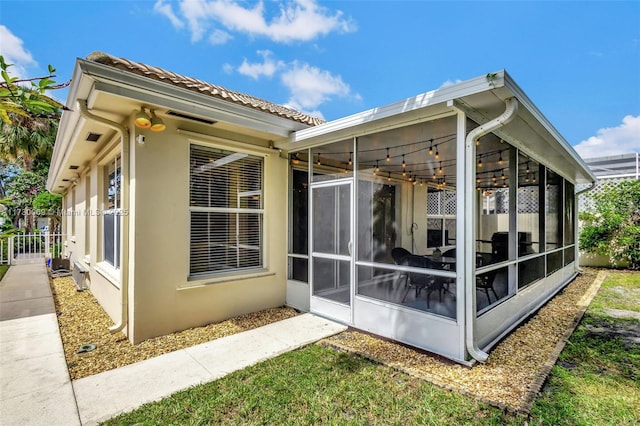 view of side of property with a sunroom