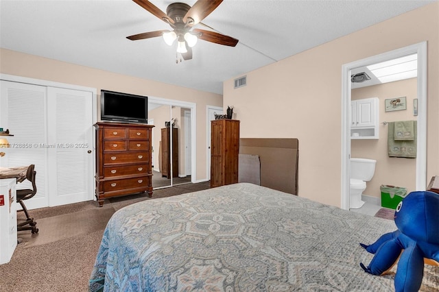 carpeted bedroom with ensuite bath and ceiling fan