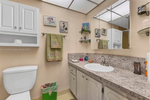 bathroom with vanity, toilet, and tile patterned floors