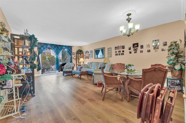 dining space with light wood-type flooring and a chandelier