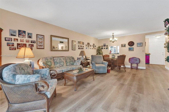 living room with light hardwood / wood-style floors and a chandelier