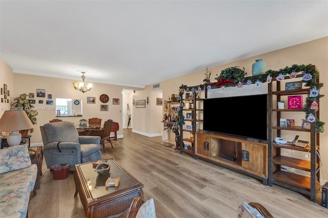 living room featuring hardwood / wood-style floors and a notable chandelier