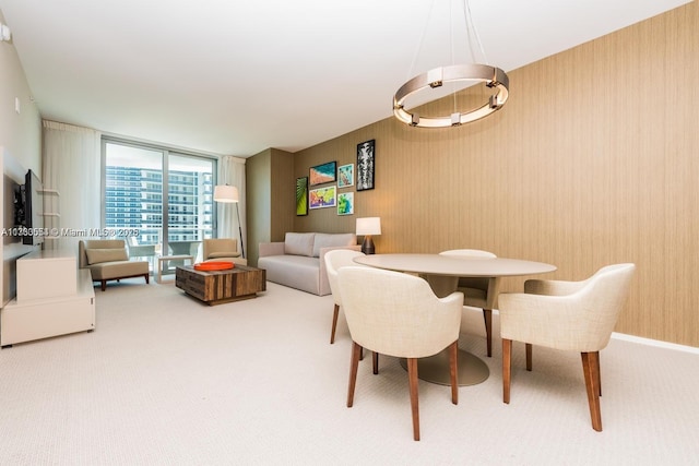 carpeted dining space featuring floor to ceiling windows