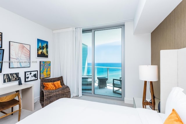 carpeted bedroom with access to exterior, a water view, floor to ceiling windows, and multiple windows