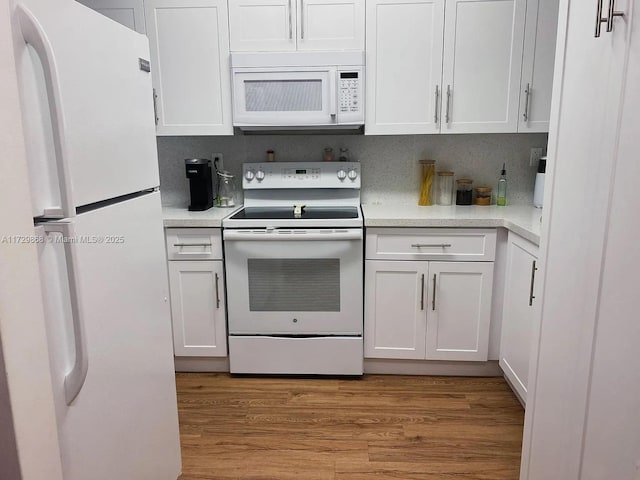 kitchen featuring light hardwood / wood-style floors, backsplash, white appliances, and white cabinets