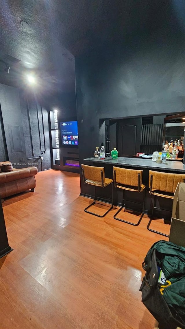 interior space with wood-type flooring and a textured ceiling