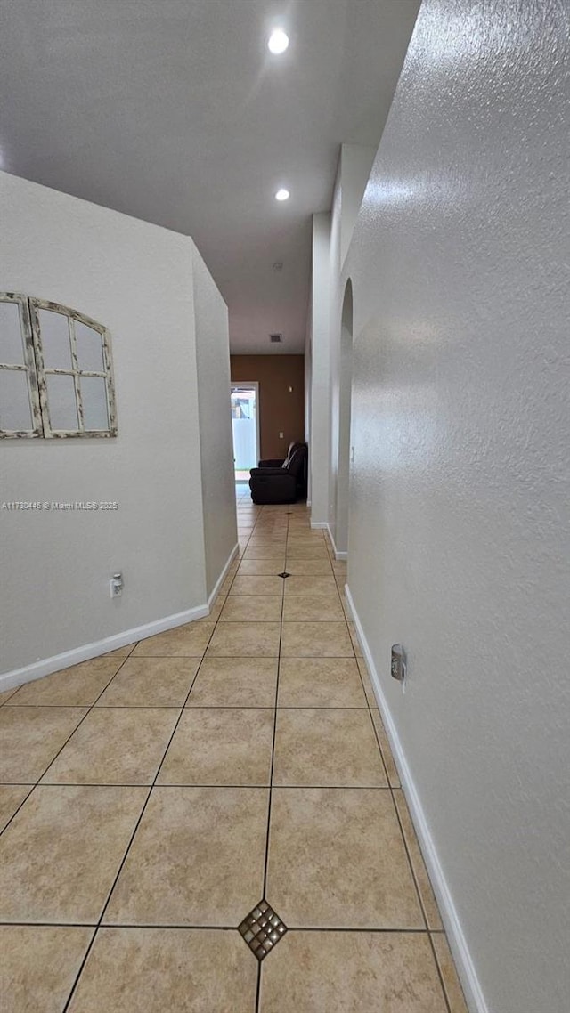 hallway featuring light tile patterned flooring