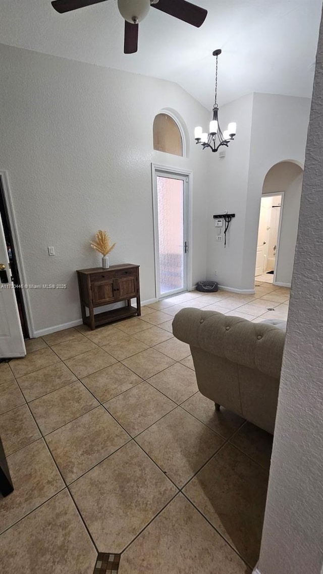 interior space featuring tile patterned flooring and vaulted ceiling