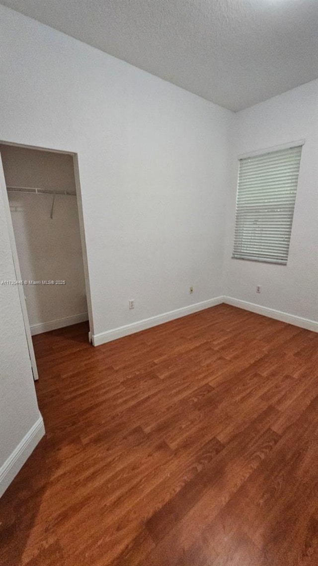 spare room featuring dark hardwood / wood-style flooring