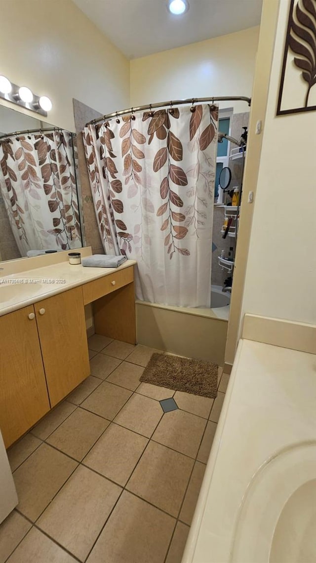 bathroom featuring shower / bath combo with shower curtain, tile patterned flooring, and vanity