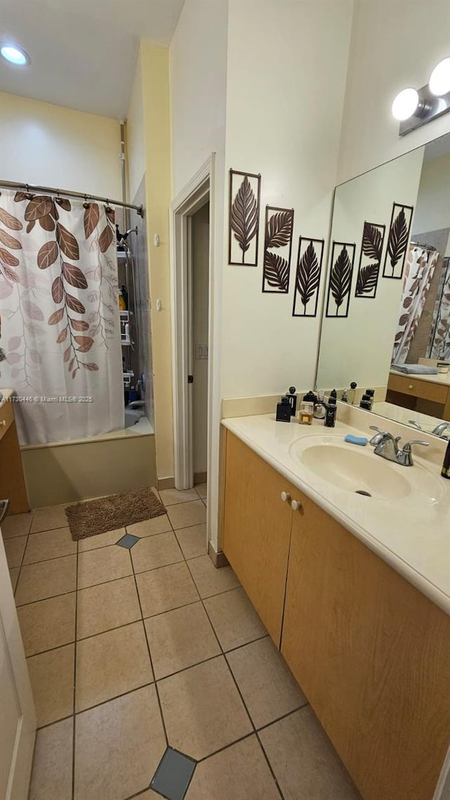 bathroom featuring tile patterned floors, shower / bathtub combination with curtain, and vanity