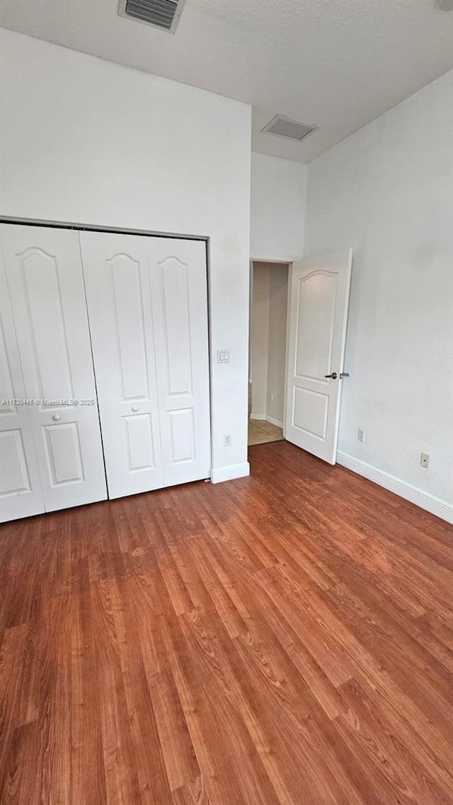 unfurnished bedroom featuring a closet and light hardwood / wood-style flooring