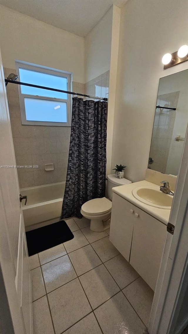 full bathroom featuring tile patterned flooring, toilet, vanity, and shower / bath combination with curtain