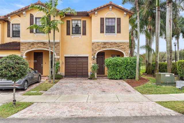 mediterranean / spanish-style house with a garage