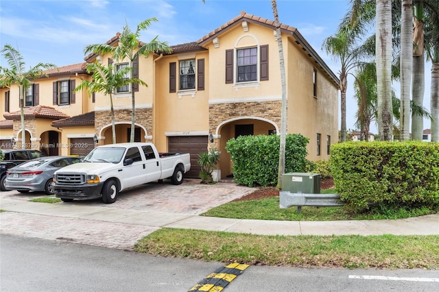 mediterranean / spanish-style home with a garage