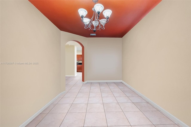 interior space with light tile patterned floors and an inviting chandelier