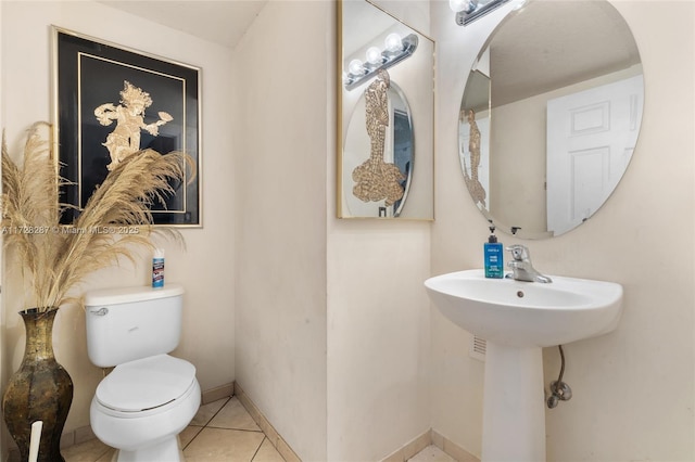 bathroom featuring toilet and tile patterned floors