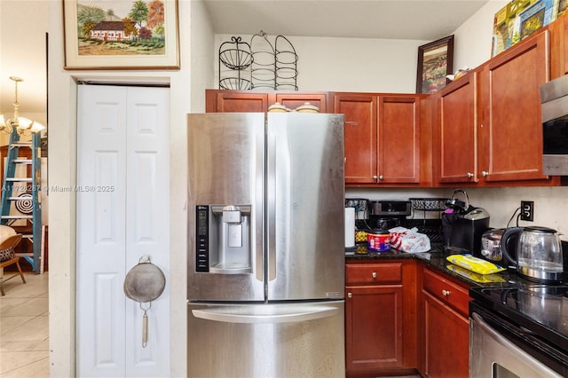 kitchen featuring light tile patterned flooring and stainless steel appliances