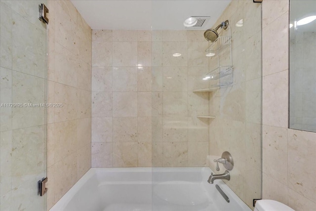 bathroom with enclosed tub / shower combo and toilet