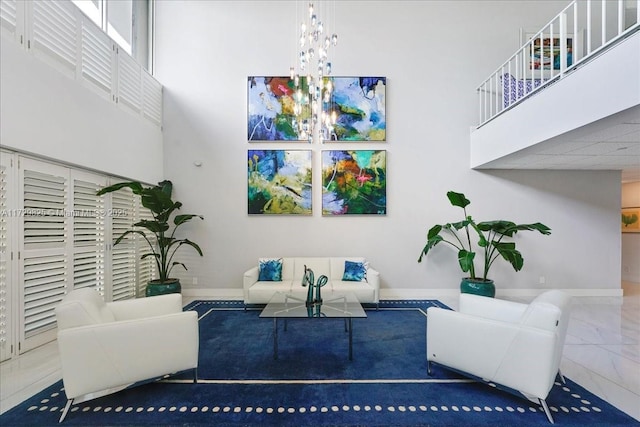 living room with an inviting chandelier and a towering ceiling