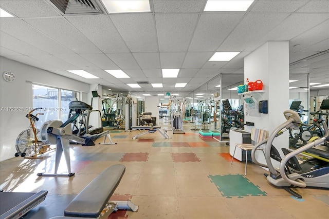 workout area with a paneled ceiling