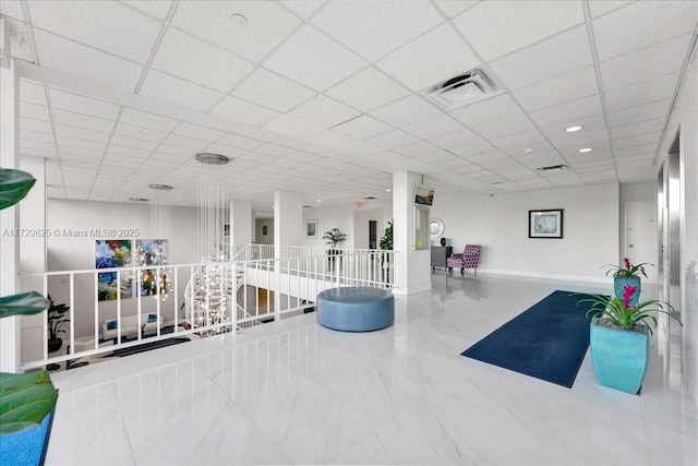 workout room with a paneled ceiling