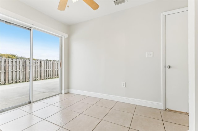 tiled empty room with ceiling fan