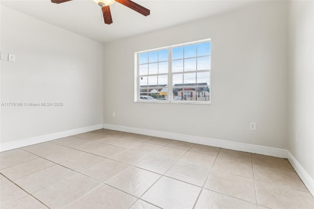 empty room with ceiling fan and light tile patterned floors