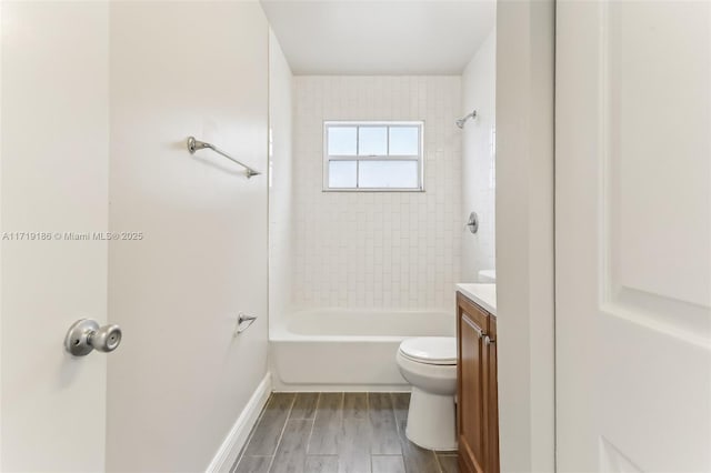 full bathroom featuring tiled shower / bath combo, toilet, and vanity