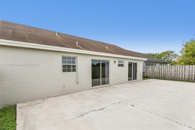 back of property with a patio