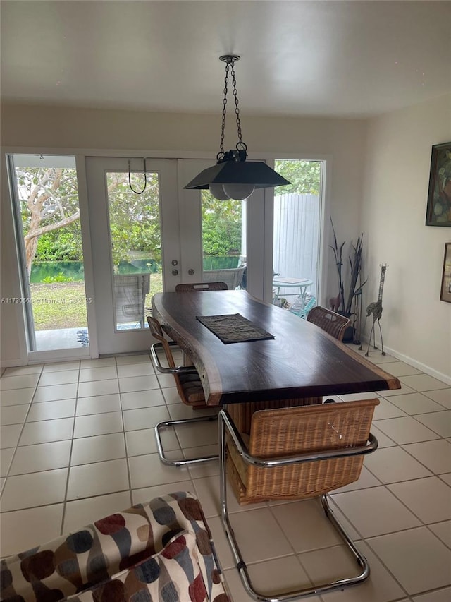 dining room with a wealth of natural light and light tile patterned flooring