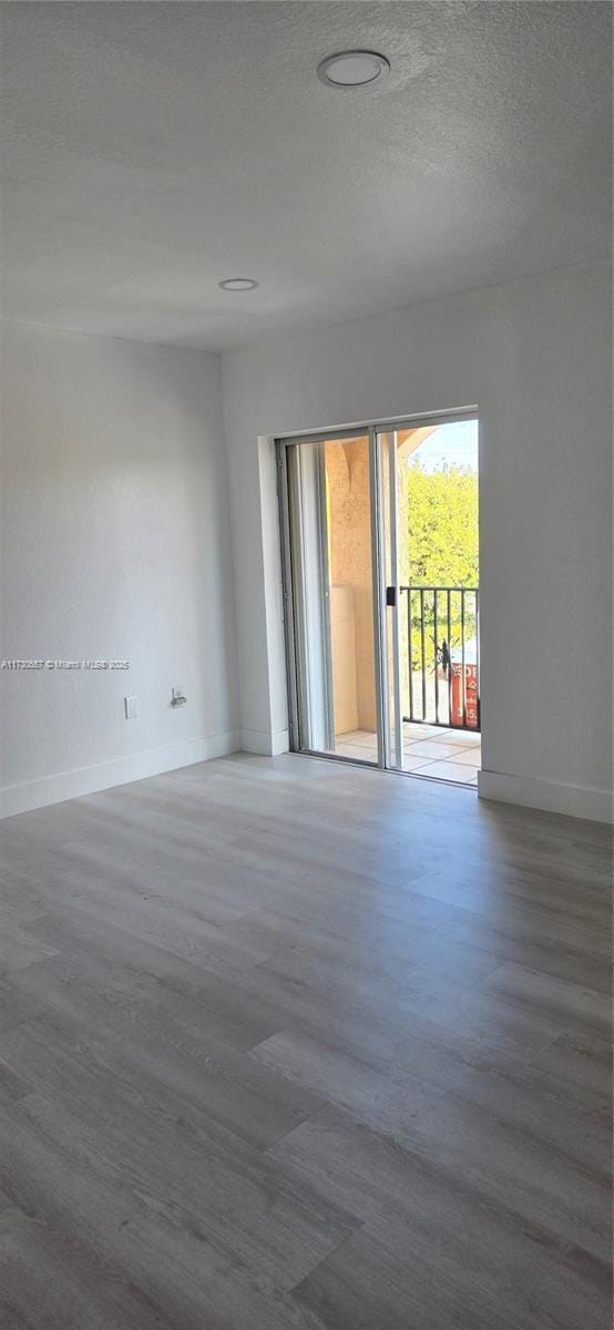 unfurnished room featuring a textured ceiling