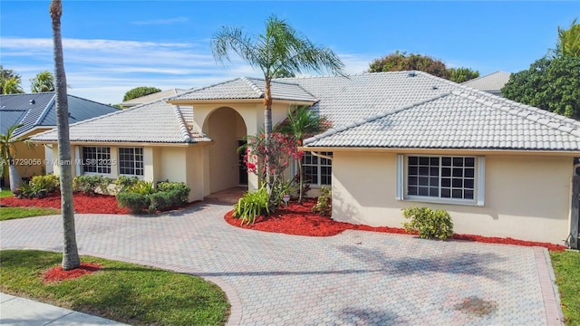 view of front of home featuring stucco siding and a tile roof