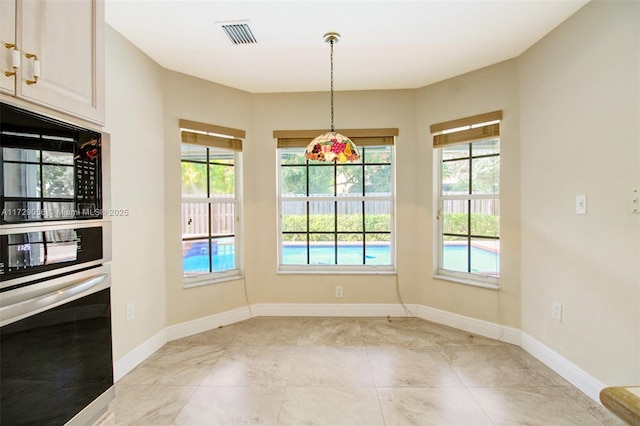 unfurnished dining area featuring visible vents and baseboards